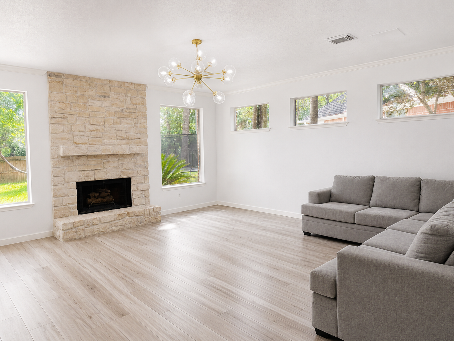 Comfortable seating, beautiful natural light, and the stone fireplace make this living room the heart of the home. Comfortable seating, beautiful natural light, and the stone fireplace make this living room the heart of the home.